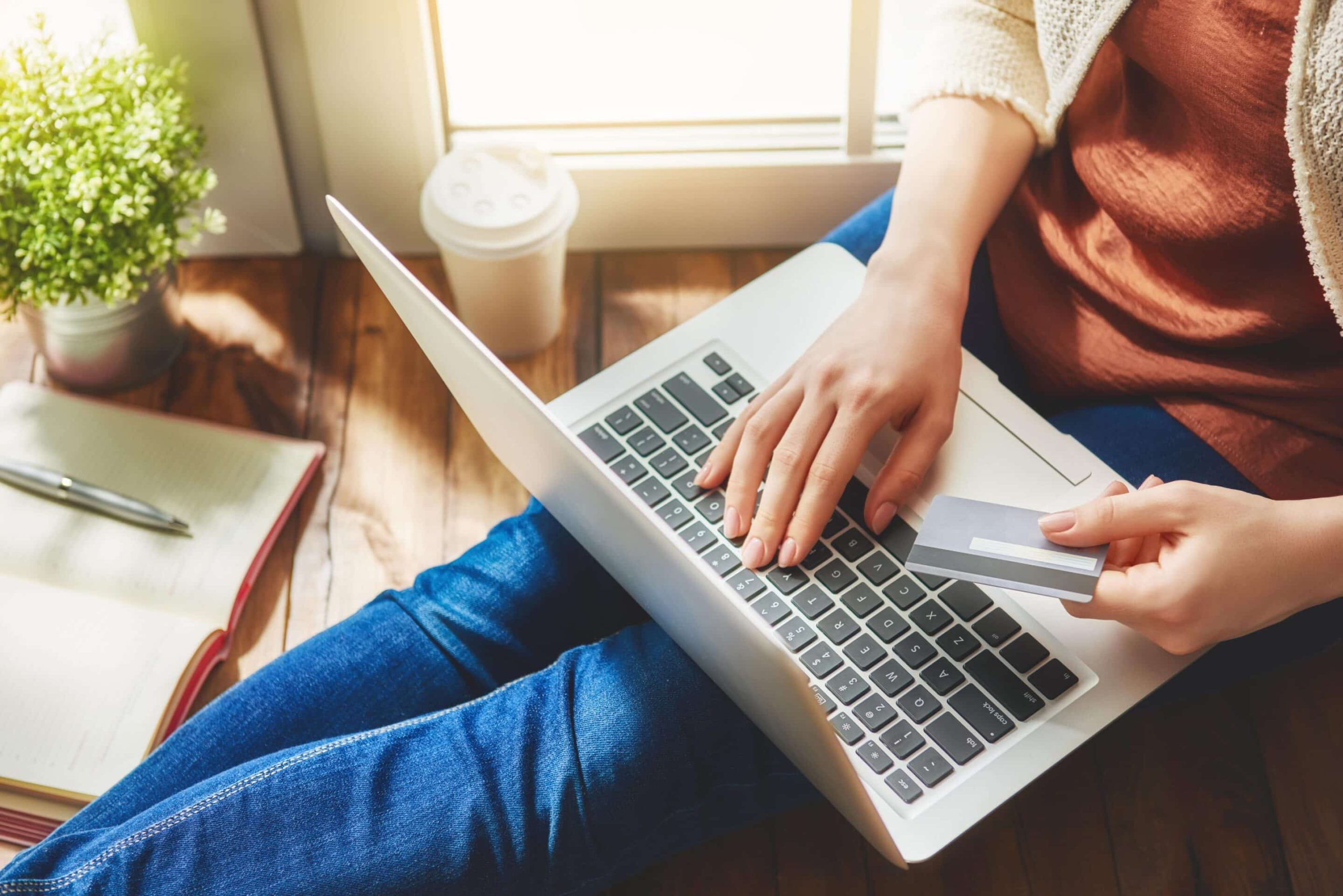 woman using laptop and credit card to make purchase